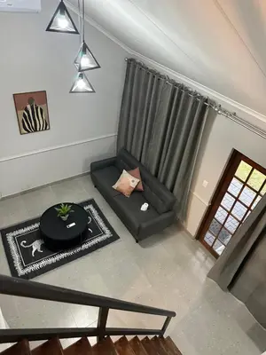 a living room with a couch and a table at Pendleberry Grove 90 in Bela-Bela