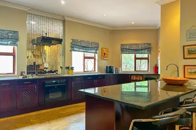 a large kitchen with a large island in the middle at Elements Bush Villa 18 in Warmbaths
