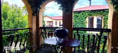 a balcony with a hat on a table on a porch at Olive & Ivy Cherry Grove 7 in Dullstroom