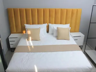 a bedroom with a large bed with white pillows at MRF Lodge in Louis Trichardt
