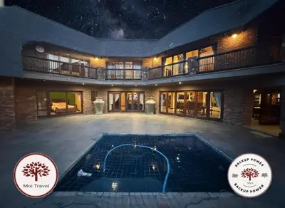 a house with a swimming pool at night at Zebula - Bushveld Waters - 20 Pax in Warmbaths