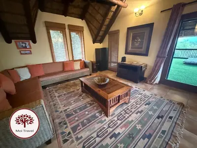 a living room with a couch and a coffee table at Zebula - Bushveld Waters - 20 Pax in Warmbaths