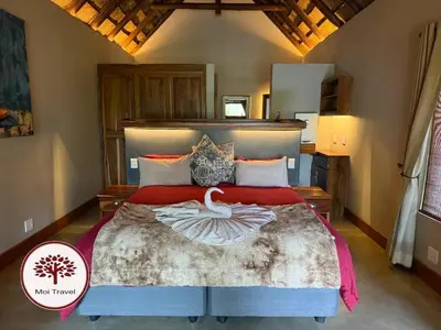 a bedroom with a large bed in a room at Zebula - Bushveld Waters - 20 Pax in Warmbaths
