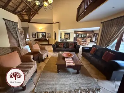 a living room with couches and a coffee table at Zebula - Bushveld Waters - 20 Pax in Warmbaths