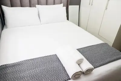a bed in an airplane with two towels on it at Grace View Guest House in Chartwell