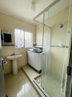 a bathroom with a shower and a sink and a stove at Mbombela Stay in Nelspruit