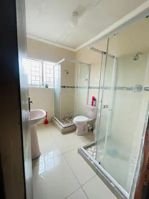 a bathroom with a shower and a toilet and a sink at Mbombela Stay in Nelspruit