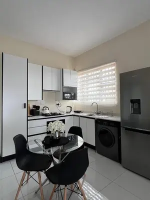 a kitchen with a table and chairs in a kitchen at The Hill in Boschrand
