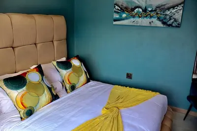 a bedroom with a bed with a headboard at De Rams boutique guest house