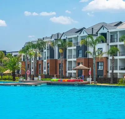 a large swimming pool in front of a building at The Legacy at The Blyde in Pretoria