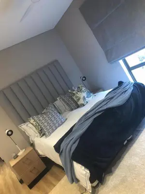 a bedroom with a large bed and a window at Walkerson Estate Country Home in Dullstroom