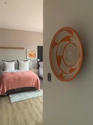 a bedroom with a bed and a large fan on the wall at Walkerson Estate Country Home in Dullstroom