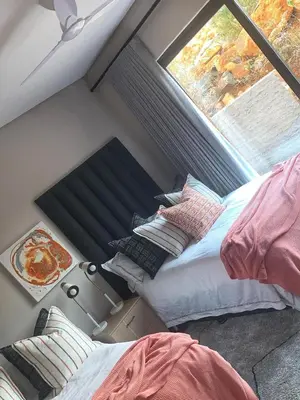 a bed in a room with a window and a bed sidx sidx sidx at Walkerson Estate Country Home in Dullstroom