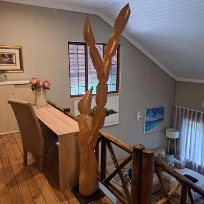 a dining room with a table and a cactus at Kruger Tree Lodge in Marloth Park