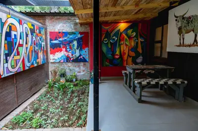 a room with paintings on the walls and a bench at Gillford Alley luxury bachelor living in Benoni