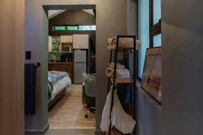 a room with a hallway with a bedroom and a kitchen at Gillford Alley luxury bachelor living in Benoni