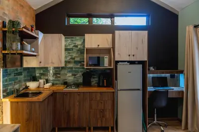 a kitchen with wooden cabinets and a refrigerator at Gillford Alley luxury bachelor living in Benoni