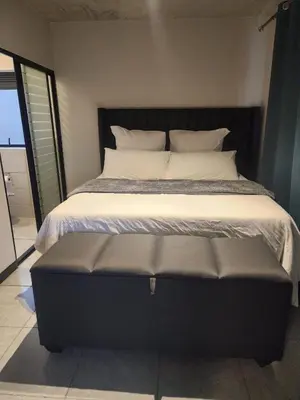 a bedroom with a large bed with a black headboard at The pentagon luxury in Midrand