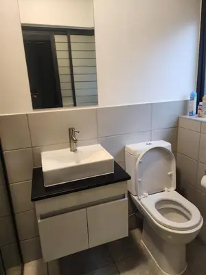 a bathroom with a white toilet and a sink at The pentagon luxury in Midrand
