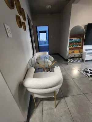 a room with two white chairs in a room at The pentagon luxury in Midrand
