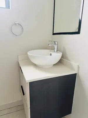a bathroom with a white sink and a mirror at High End 93 On New Stay in Midrand