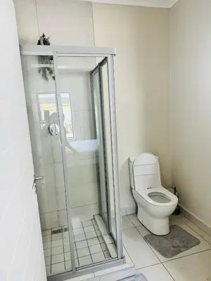 a bathroom with a shower and a toilet at High End 93 On New Stay in Midrand