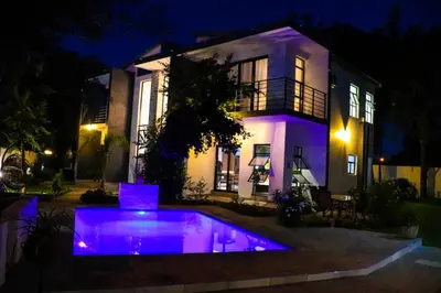 a house with a swimming pool at night at Bayley Boutique Guesthouse & Hydro Spa in Benoni