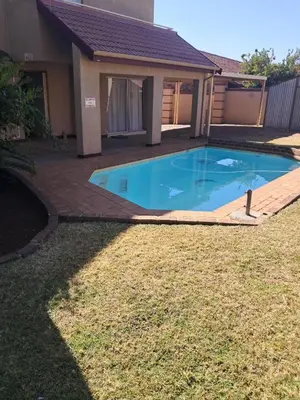 a swimming pool in the backyard of a house at African Nights in Pretoria