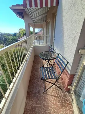 a balcony with two chairs and a table on it at African Nights in Pretoria