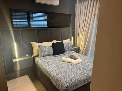 a bedroom with a bed with two towels on it at Waterkloof Park in Pretoria