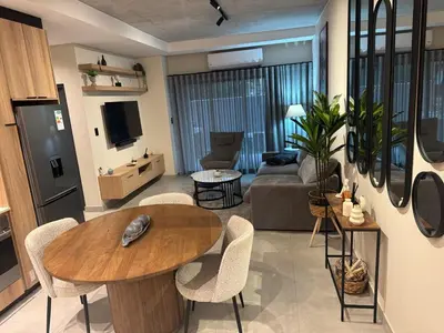 a living room with a table and a couch at Waterkloof Park in Pretoria