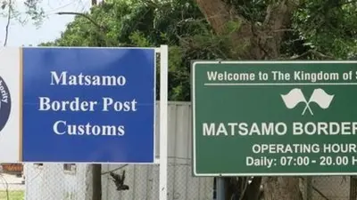 two street signs in front of a fence at Mbombela Sunrise Retreat in Boschrand