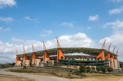 a large stadium with a building with orange at Mbombela Sunrise Retreat in Boschrand