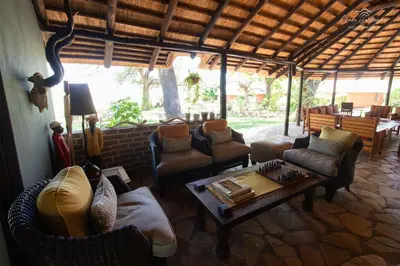 a living room with couches and chairs and a table at Mohlabetsi Safari Lodge in Hoedspruit