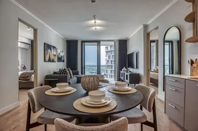 a kitchen and living room with a table and chairs at Stormside at Ellipse in Midrand