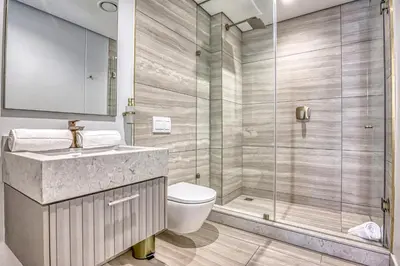 a bathroom with a toilet and a glass shower at Stormside at Ellipse in Midrand