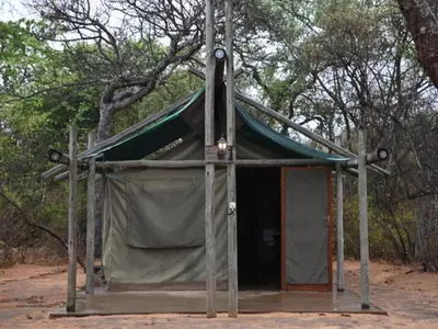 a small tent with a green tarp on it at Awelani Eco Tourism Lodge in Masisi