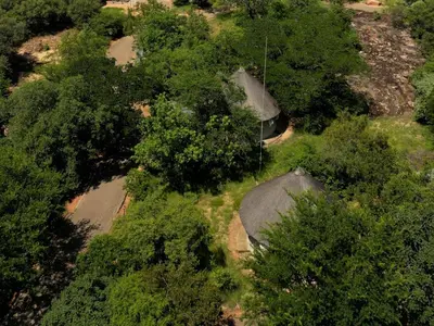 an overhead view of a house with trees at Awelani Eco Tourism Lodge in Masisi