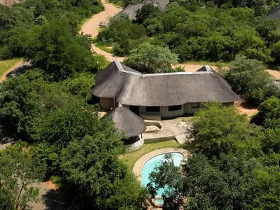 an overhead view of a house with a swimming pool at Awelani Eco Tourism Lodge in Masisi