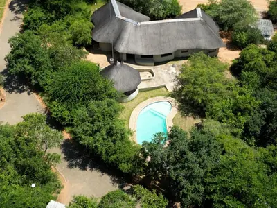 an overhead view of a house with a swimming pool at Awelani Eco Tourism Lodge in Masisi