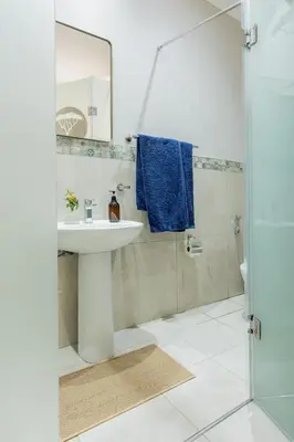a bathroom with a sink and a shower at Hacienda Destri Lodge in Wolwefontein