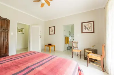 a bedroom with a bed and a table and chairs at Hacienda Destri Lodge in Wolwefontein