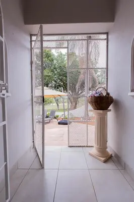 a room with a door leading to a patio at Hacienda Destri Lodge in Wolwefontein