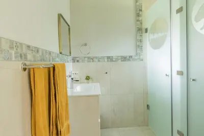 a bathroom with a sink and a shower at Hacienda Destri Lodge in Wolwefontein