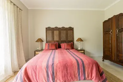 a bedroom with a large bed and two night stands at Hacienda Destri Lodge in Wolwefontein