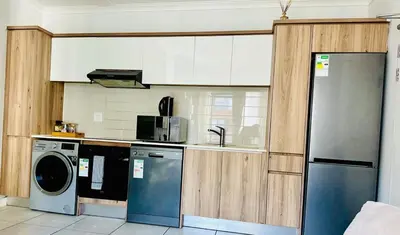 a kitchen with a dishwasher and a washer at Cosy stay at The Blyde With Lagoon in Pretoria