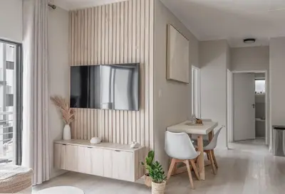 a living room with a table and a chair at Work, Travel, Relax in Pure Class in Midrand