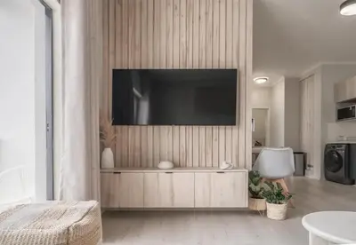 a living room with a television on a wall at Work, Travel, Relax in Pure Class in Midrand