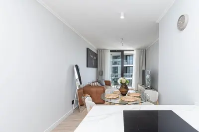 a living room with a table and a couch at Ellipse Manscave Modern Luxury Apartment in Midrand