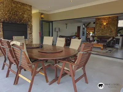 a wooden table and chairs in a living room at Mufasa's Den Zebula in Warmbaths